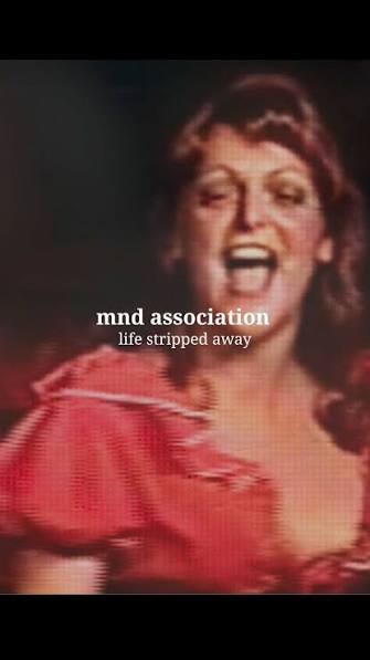 "MND Association - Life Stripped Away" is written over a still from the film of Jaki in her costume as Nancy from Oliver, her mouth is open and smiling as she sings.